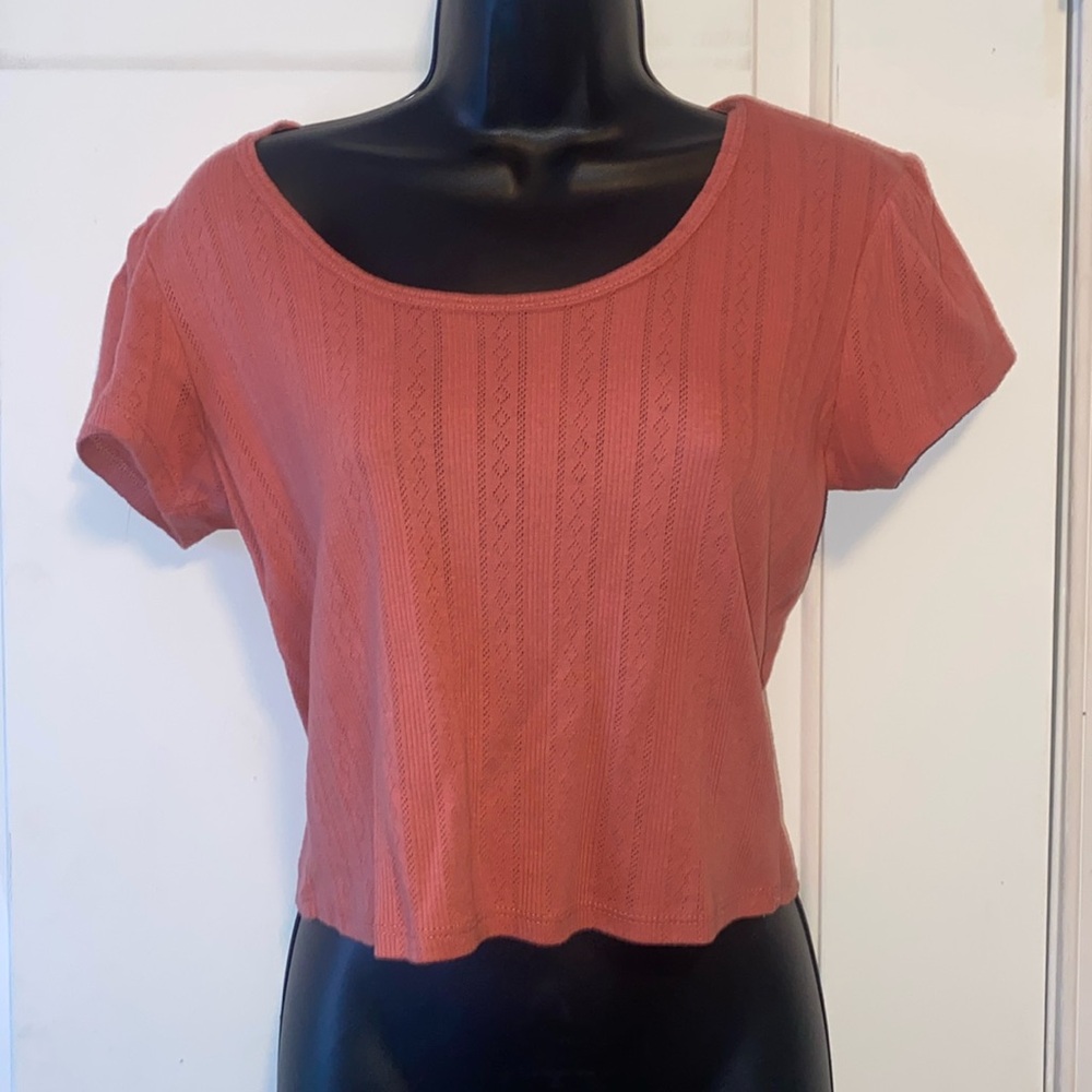 Cropped tee with tie in the back at the top.